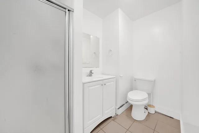 a white toilet sitting next to a bathroom sink