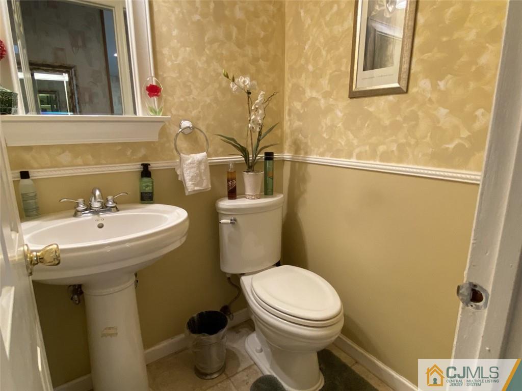58 Brookside Road Edison, NJ 08817 - Photo 12 of 34 a bathroom with a sink mirror and toilet