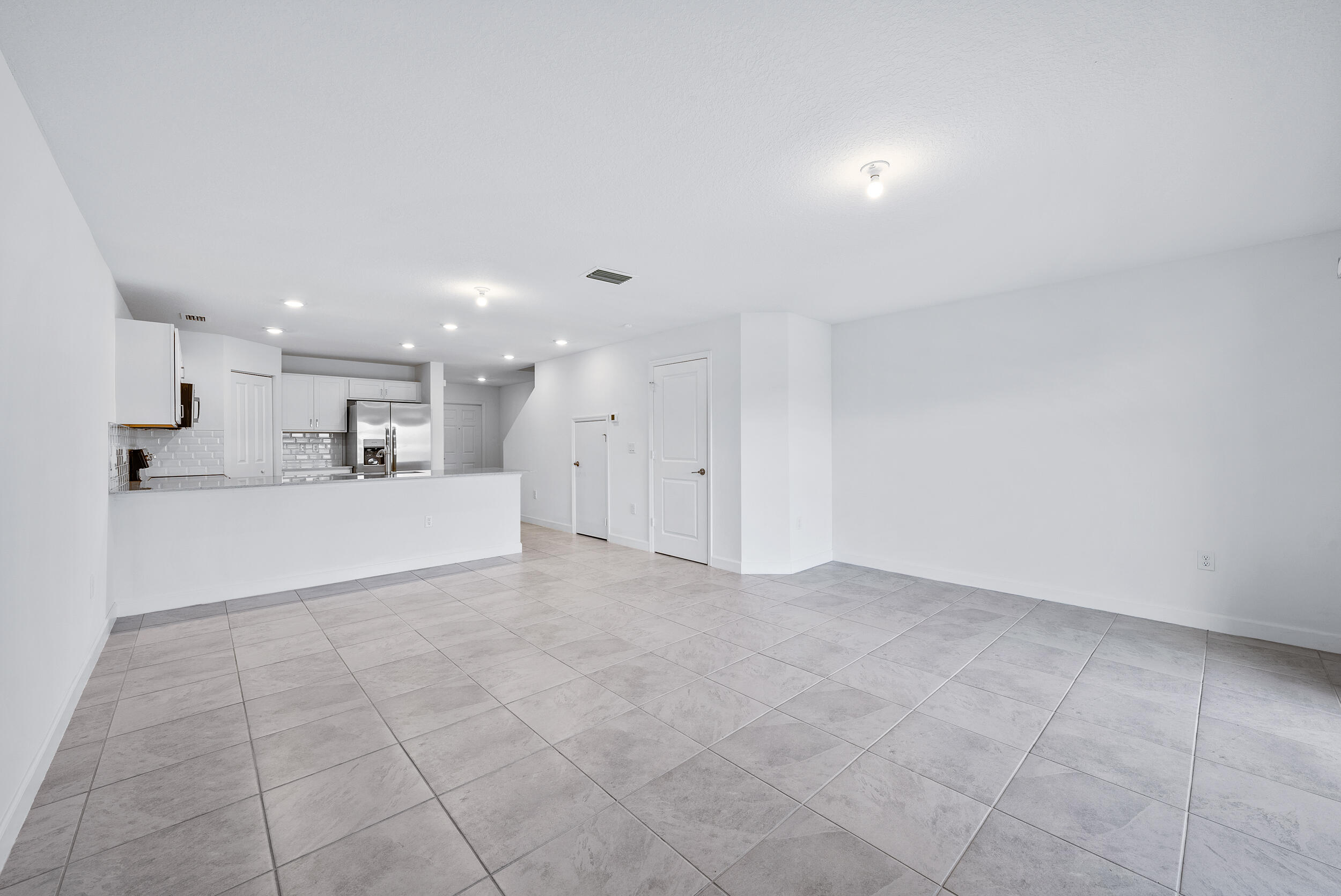 4215 Bent River Road Lake Worth, FL 33467 - Photo 13 of 29 a view of kitchen with kitchen island white cabinets and refrigerator