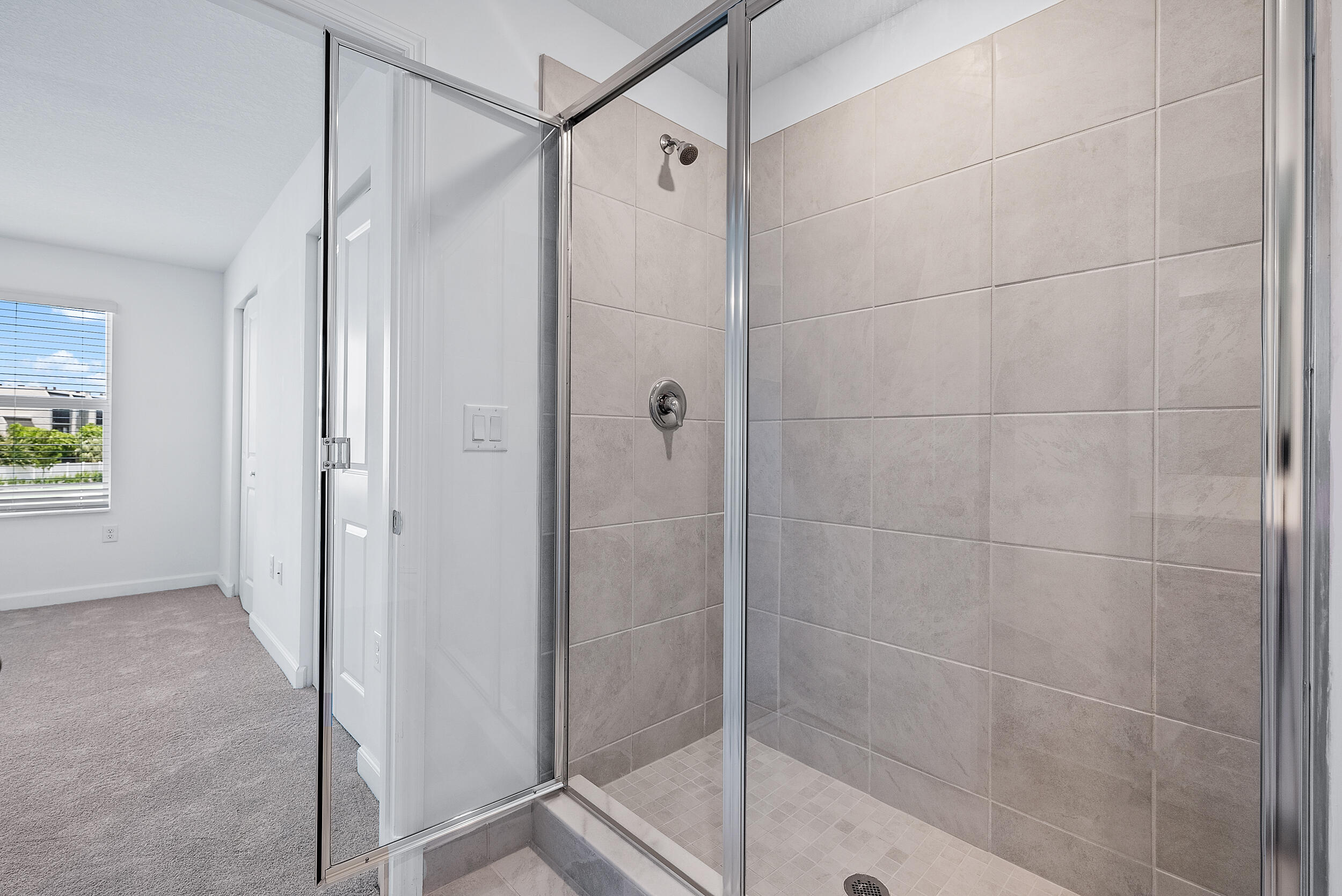 4215 Bent River Road Lake Worth, FL 33467 - Photo 19 of 29 a bathroom with a glass shower door
