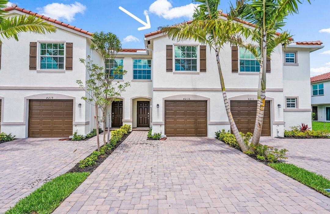 4215 Bent River Road Lake Worth, FL 33467 - Photo 2 of 29 a front view of a house with yard and parking