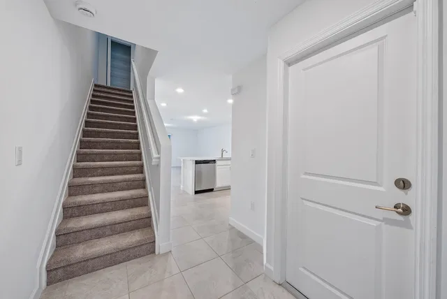a view of a hallway with stairs and ventilation
