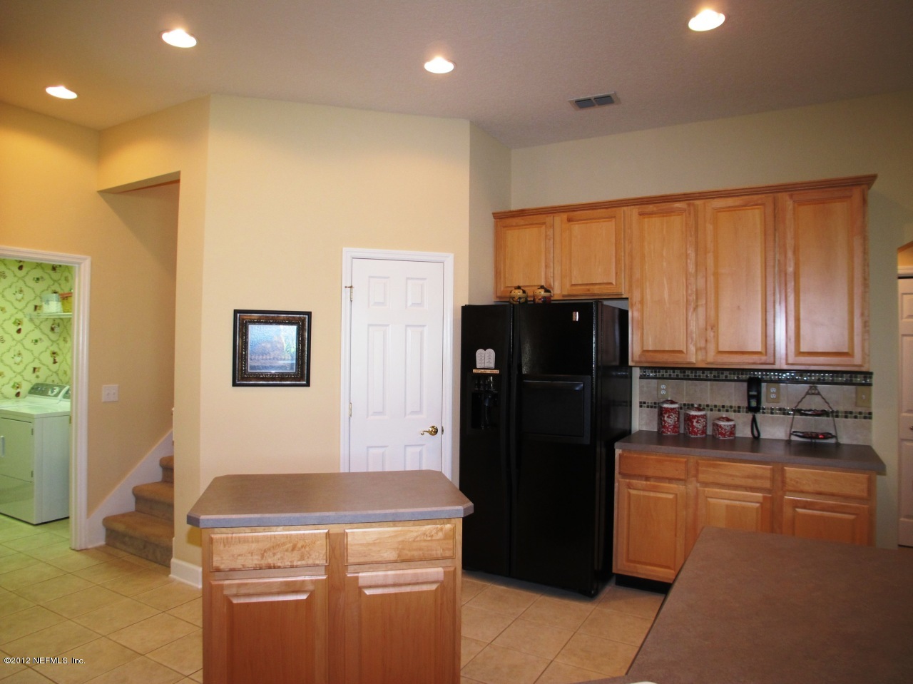 1645 Margarets Walk Road Fleming Island, FL 32003 - Photo 11 of 42 a kitchen with a refrigerator and a stove