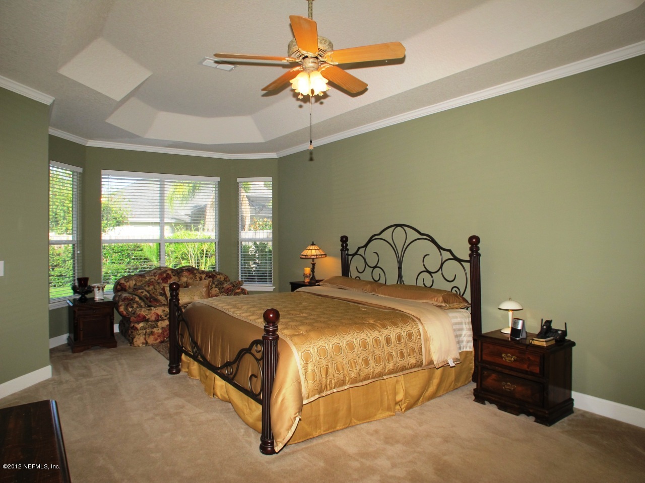 1645 Margarets Walk Road Fleming Island, FL 32003 - Photo 15 of 42 a bedroom with a bed and a chandelier