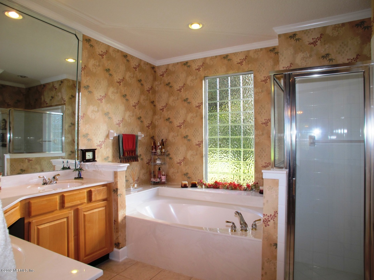 1645 Margarets Walk Road Fleming Island, FL 32003 - Photo 17 of 42 a bathroom with a tub sink and mirror