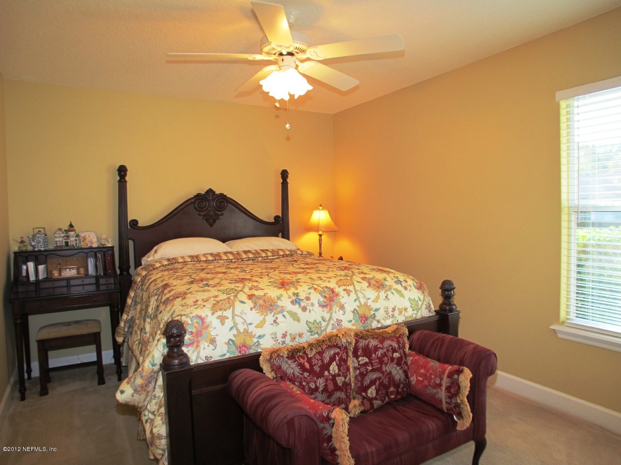1645 Margarets Walk Road Fleming Island, FL 32003 - Photo 18 of 42 a bed sitting in a bedroom next to a window