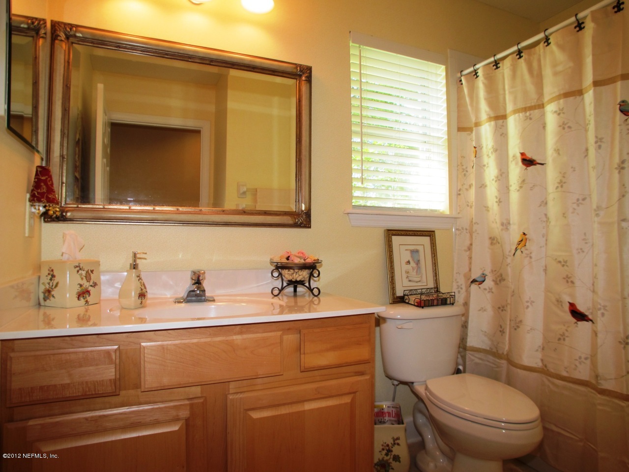 1645 Margarets Walk Road Fleming Island, FL 32003 - Photo 20 of 42 a bathroom with a toilet a sink and a mirror