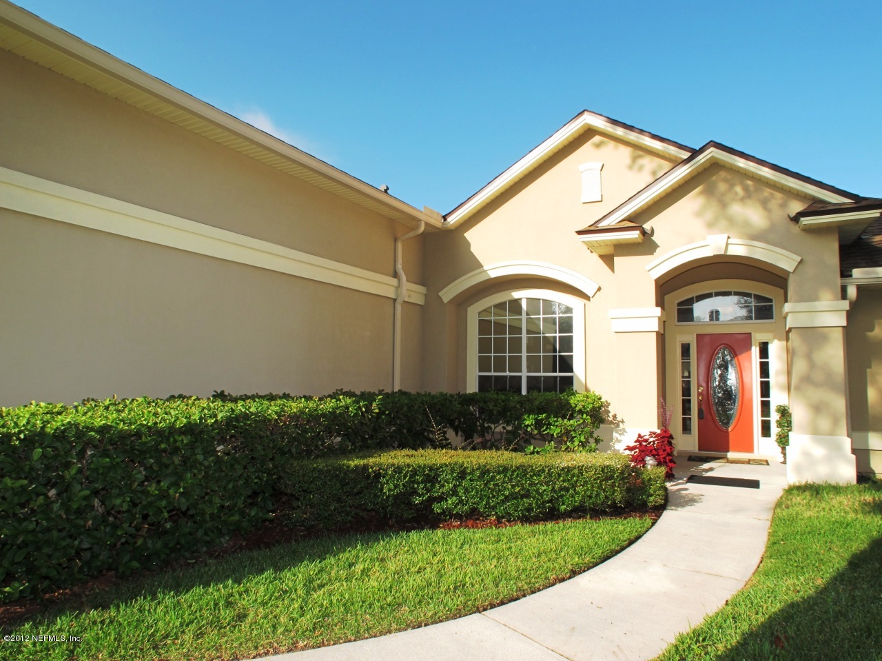 1645 Margarets Walk Road Fleming Island, FL 32003 - Photo 2 of 42 a view of a house with a small yard and plants