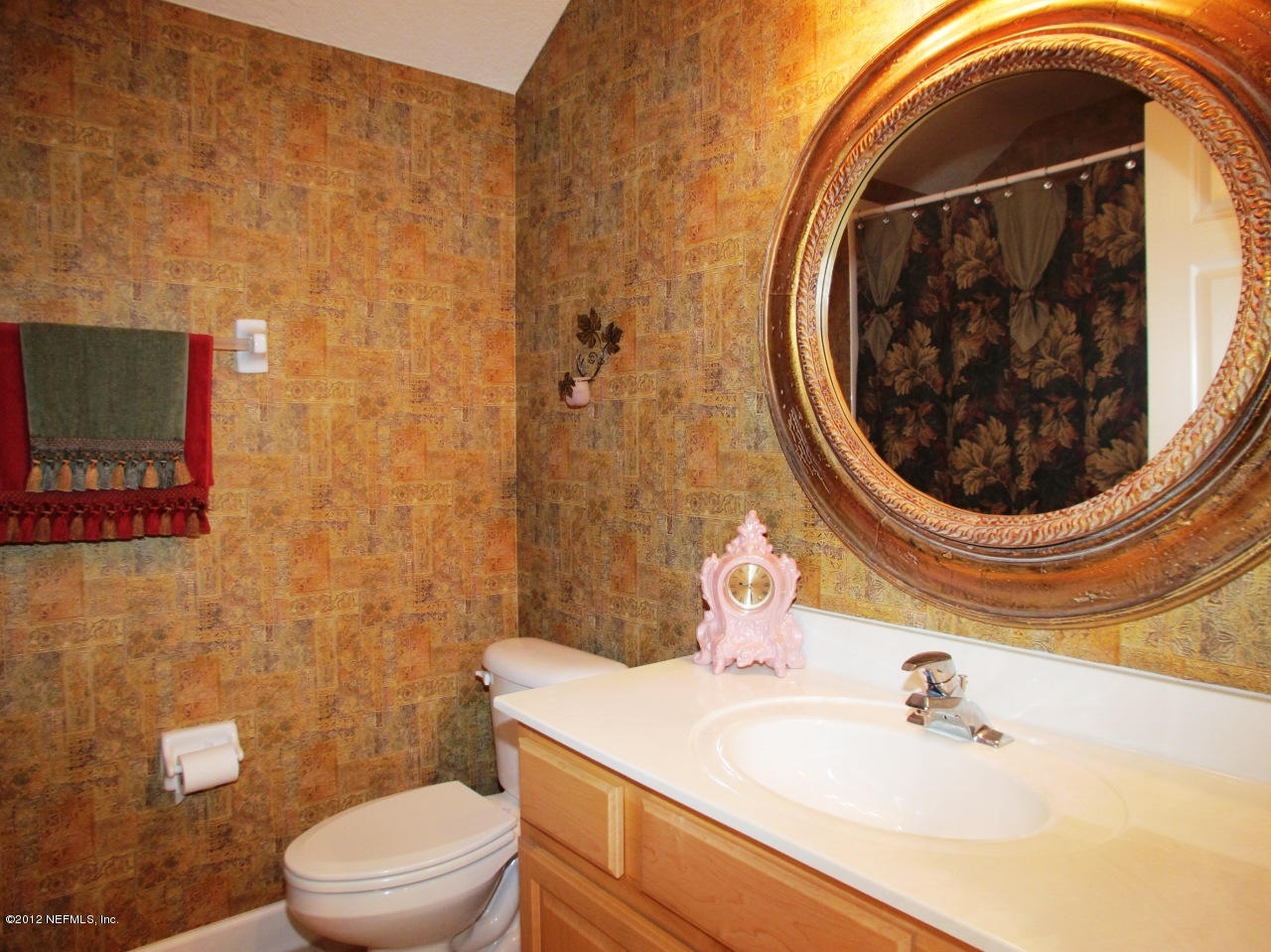 1645 Margarets Walk Road Fleming Island, FL 32003 - Photo 22 of 42 a bathroom with a sink toilet and mirror