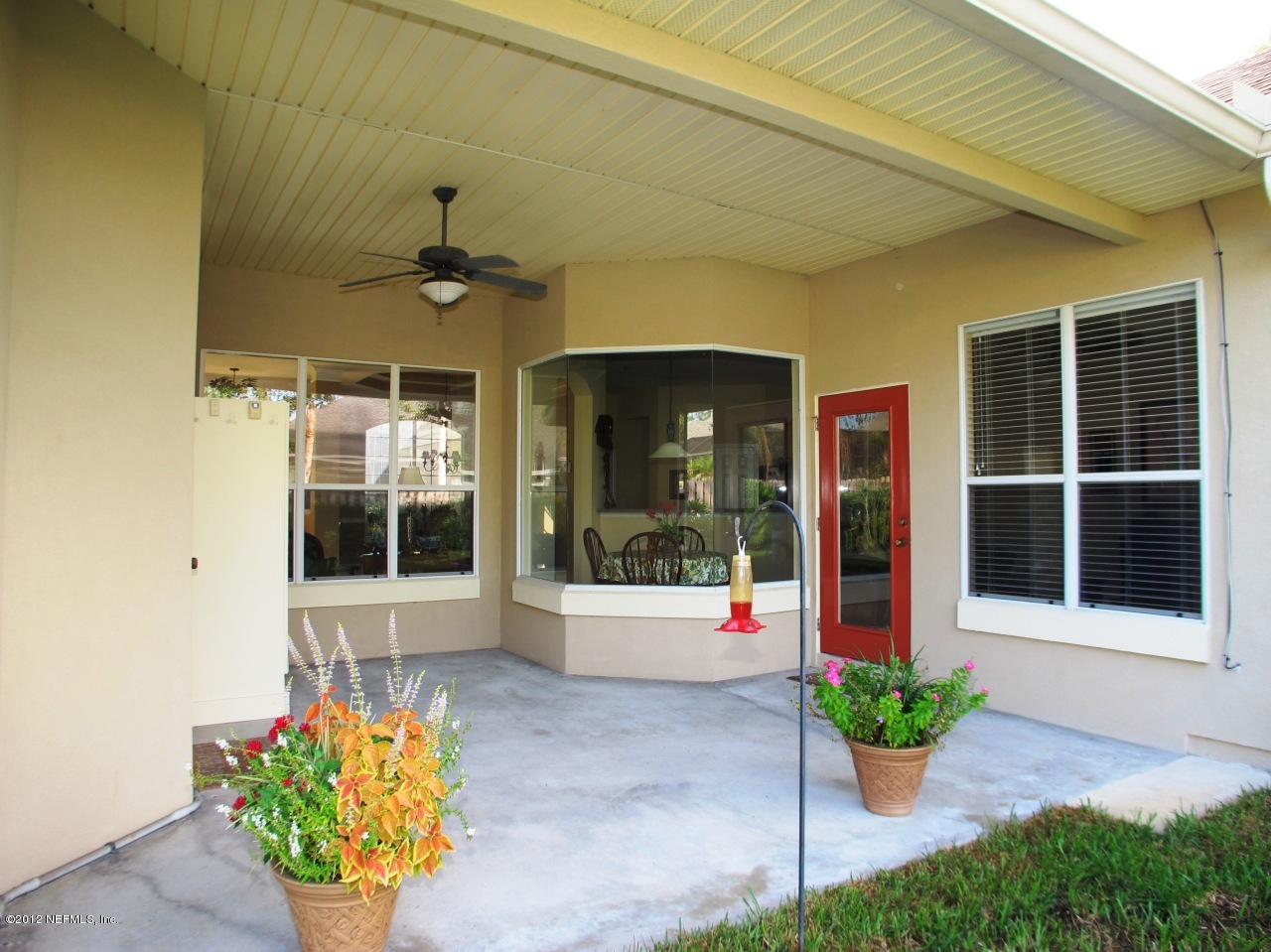 1645 Margarets Walk Road Fleming Island, FL 32003 - Photo 24 of 42 a front view of a house with a potted plant and a potted plant