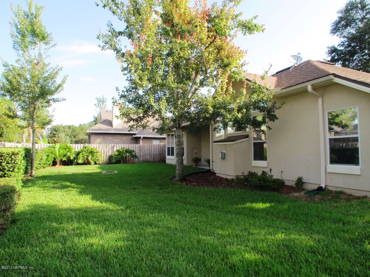 1645 Margarets Walk Road Fleming Island, FL 32003 - Photo 28 of 42 a white house that has a small yard and trees in it