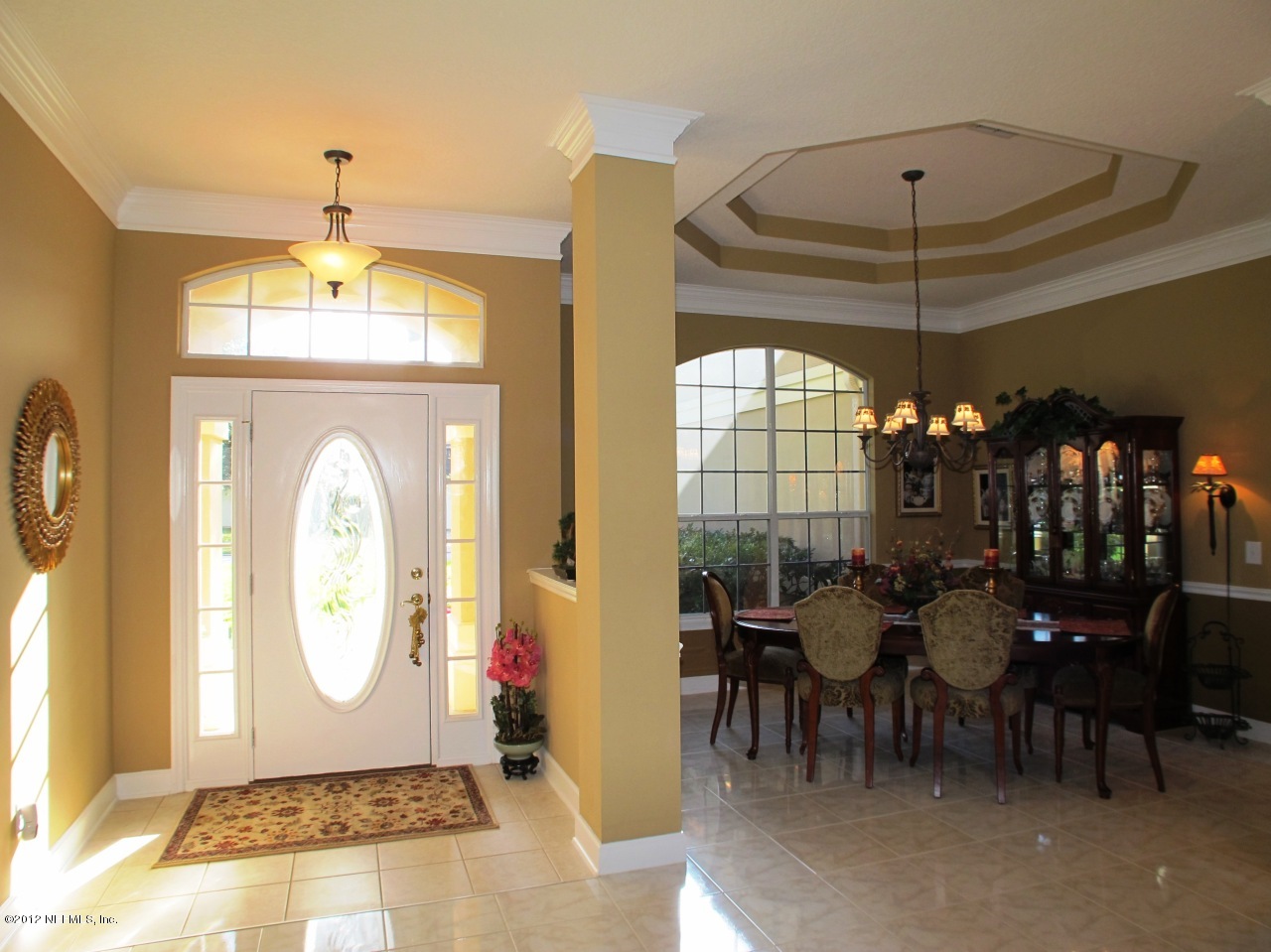 1645 Margarets Walk Road Fleming Island, FL 32003 - Photo 3 of 42 a dining room with chandelier fan and wooden floor