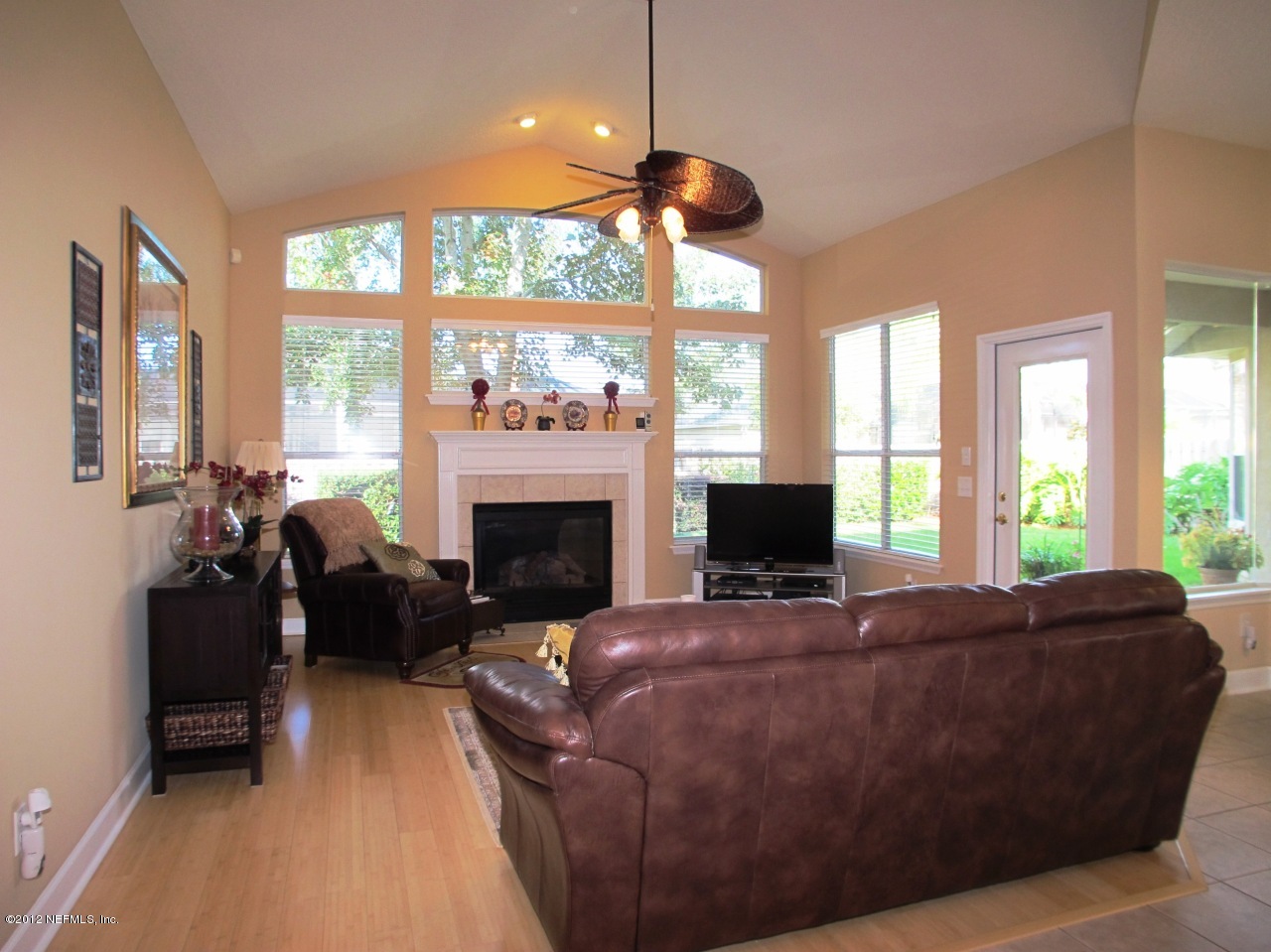 1645 Margarets Walk Road Fleming Island, FL 32003 - Photo 8 of 42 a living room with furniture a large window and a fireplace