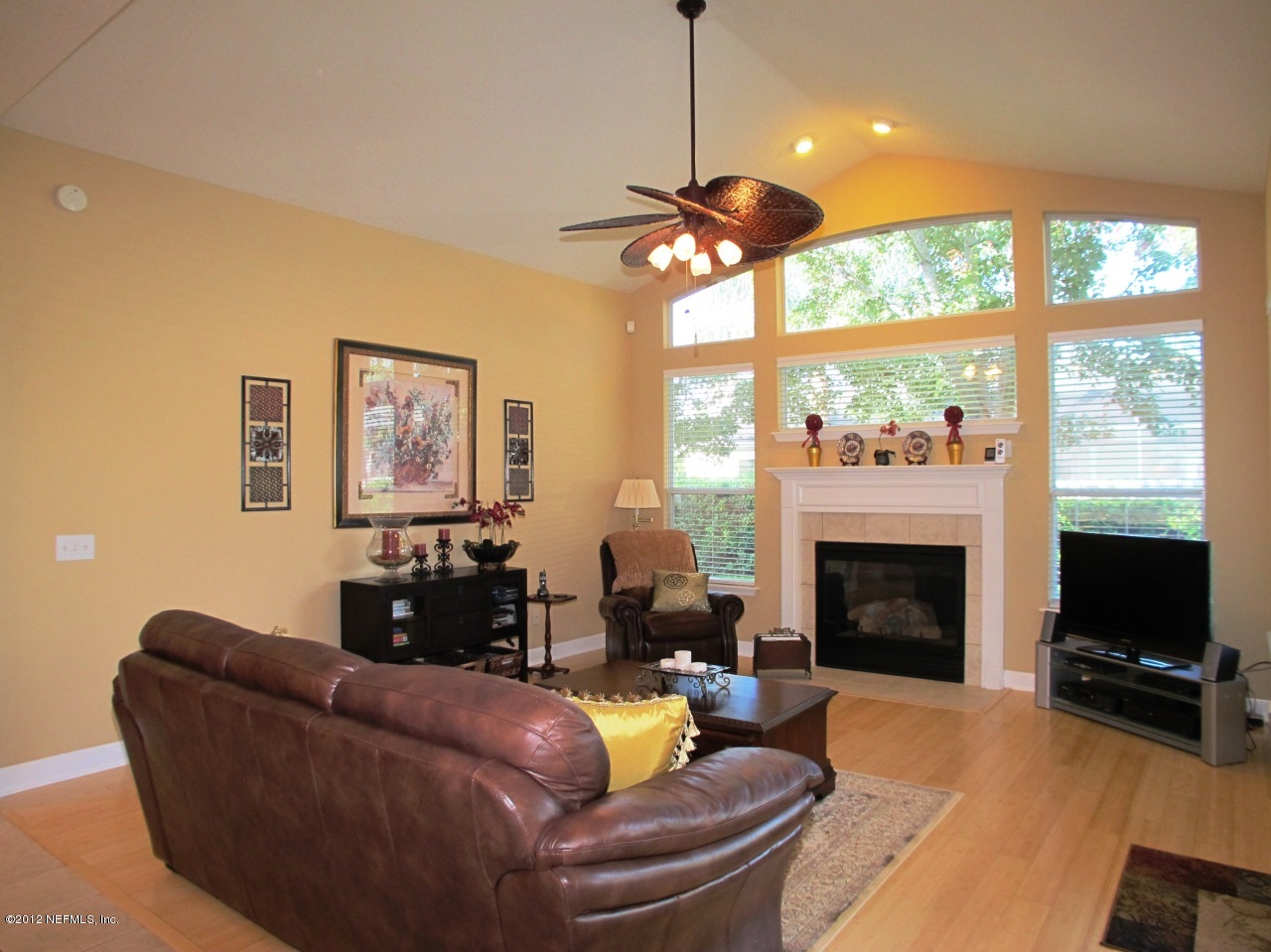 1645 Margarets Walk Road Fleming Island, FL 32003 - Photo 9 of 42 a living room with furniture a fireplace and a flat screen tv