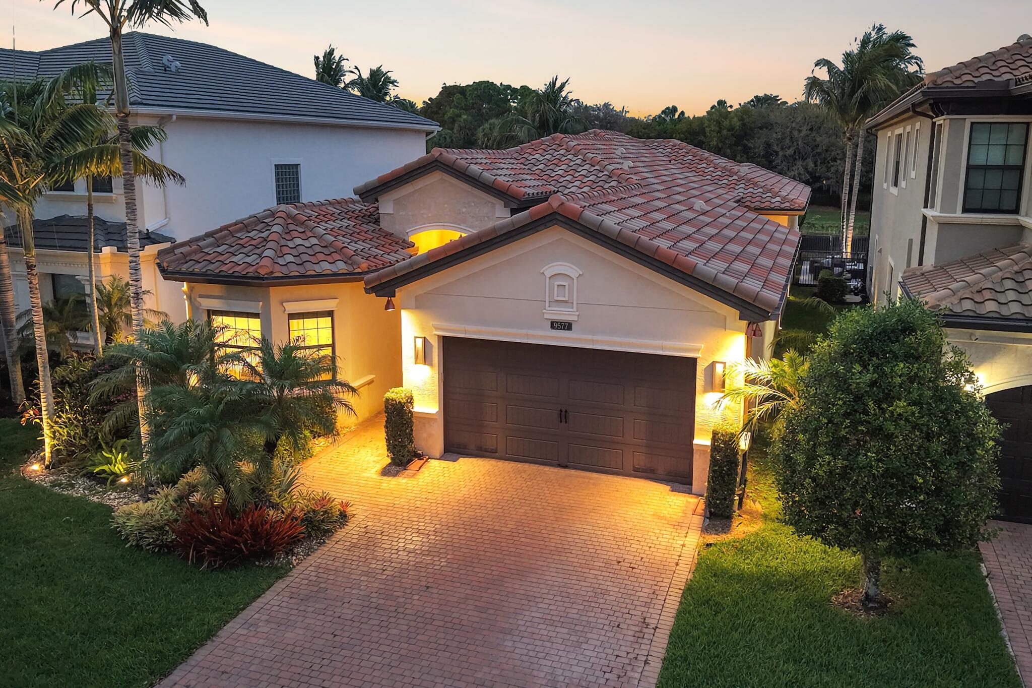 9577 Eden Roc Court Delray Beach, FL 33446 - Photo 1 of 53 a house view with a garden space