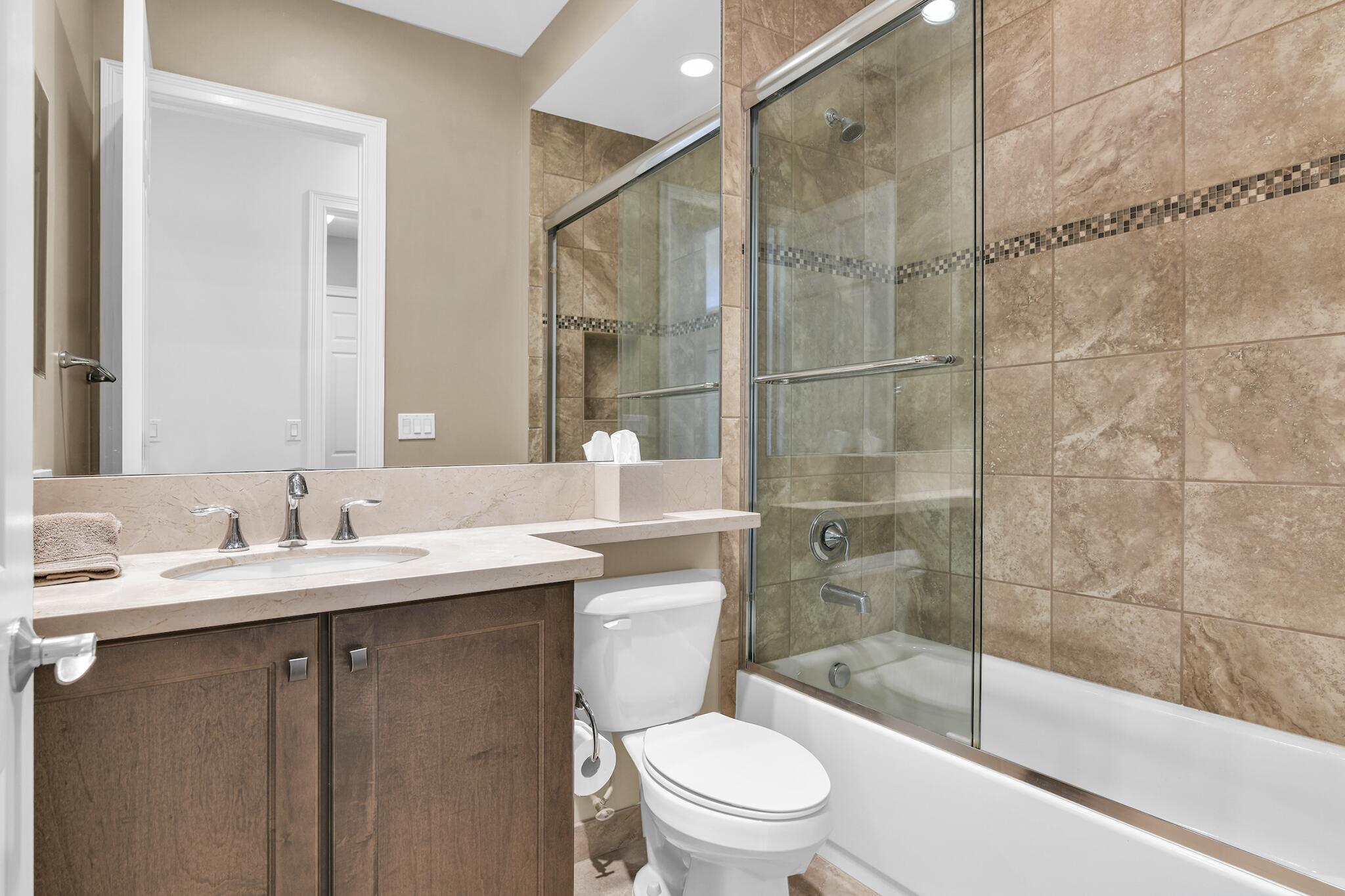 9577 Eden Roc Court Delray Beach, FL 33446 - Photo 12 of 53 a bathroom with a sink a toilet and shower