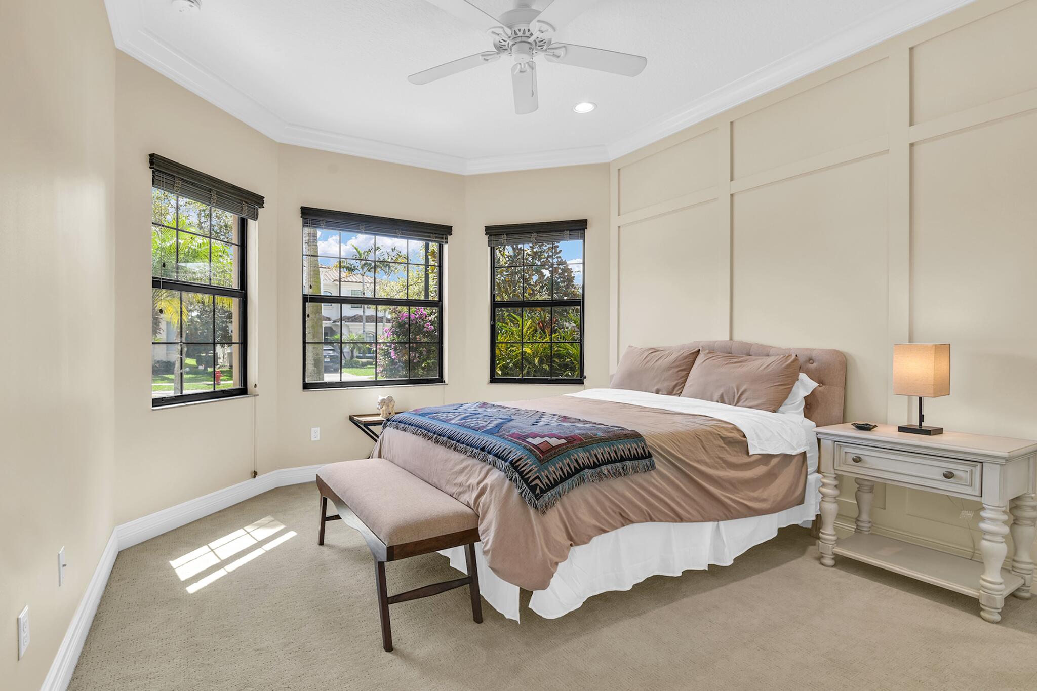 9577 Eden Roc Court Delray Beach, FL 33446 - Photo 13 of 53 a bedroom with a bed and a chandelier