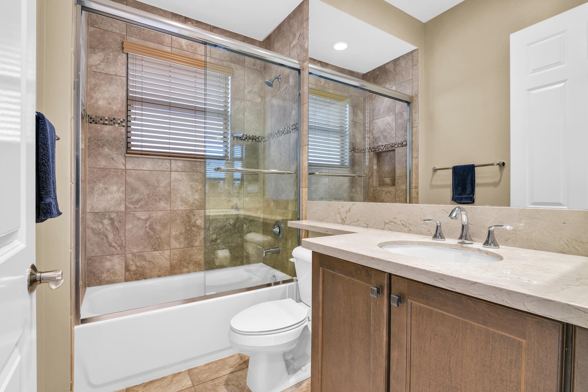 9577 Eden Roc Court Delray Beach, FL 33446 - Photo 14 of 53 a bathroom with a sink a toilet a bathtub and shower