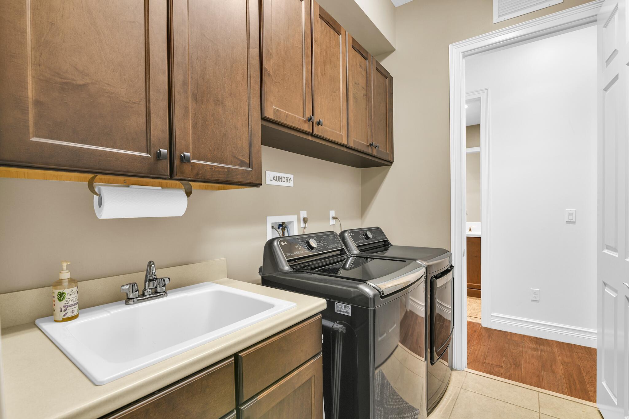9577 Eden Roc Court Delray Beach, FL 33446 - Photo 19 of 53 a utility room with sink dryer and washer