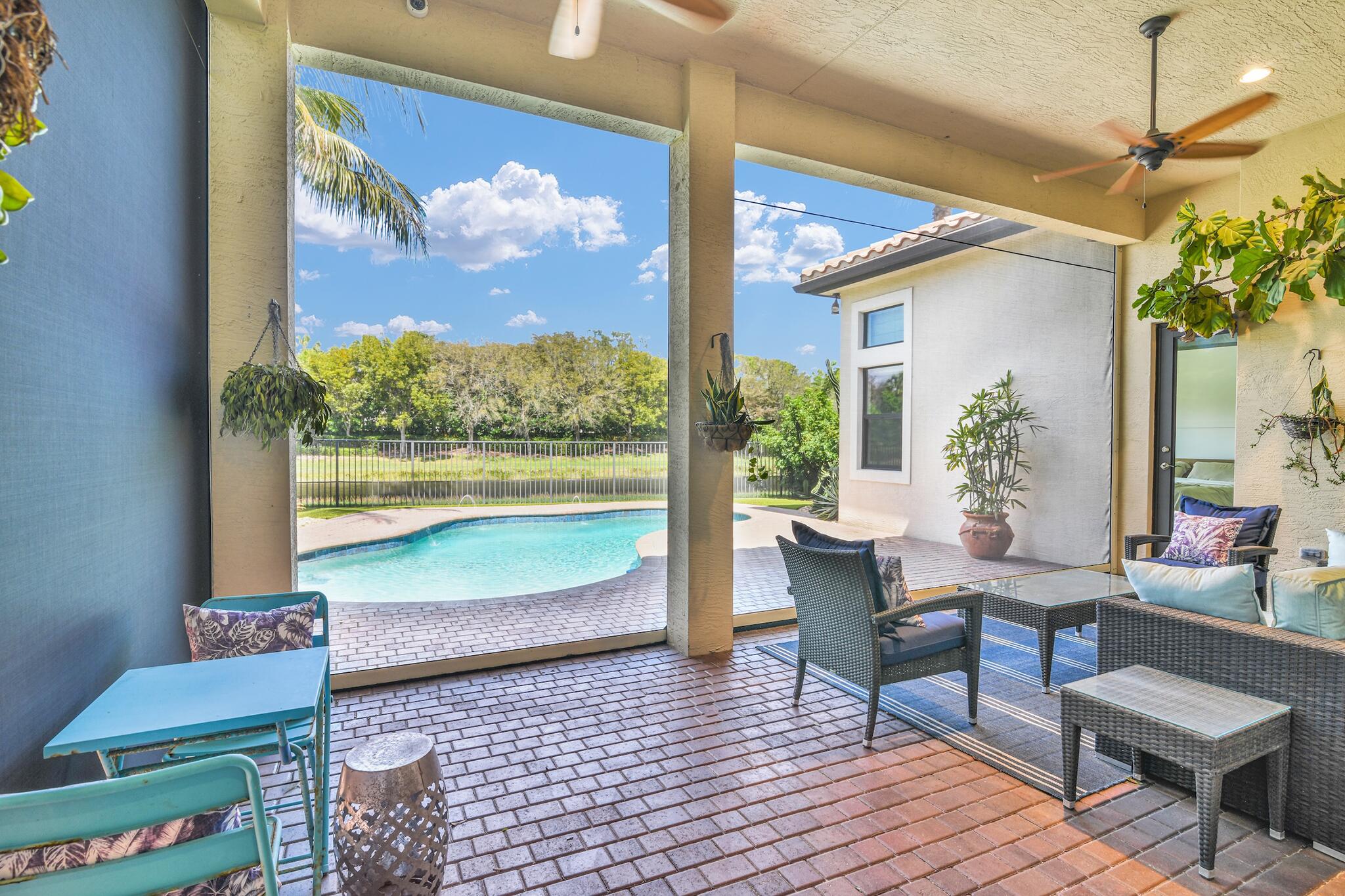 9577 Eden Roc Court Delray Beach, FL 33446 - Photo 20 of 53 a living room with furniture and a large window with wooden floor