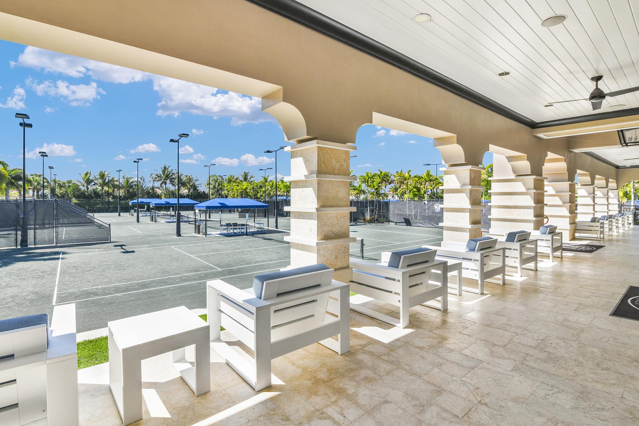 9577 Eden Roc Court Delray Beach, FL 33446 - Photo 31 of 53 a building outdoor space with patio furniture and a potted plant
