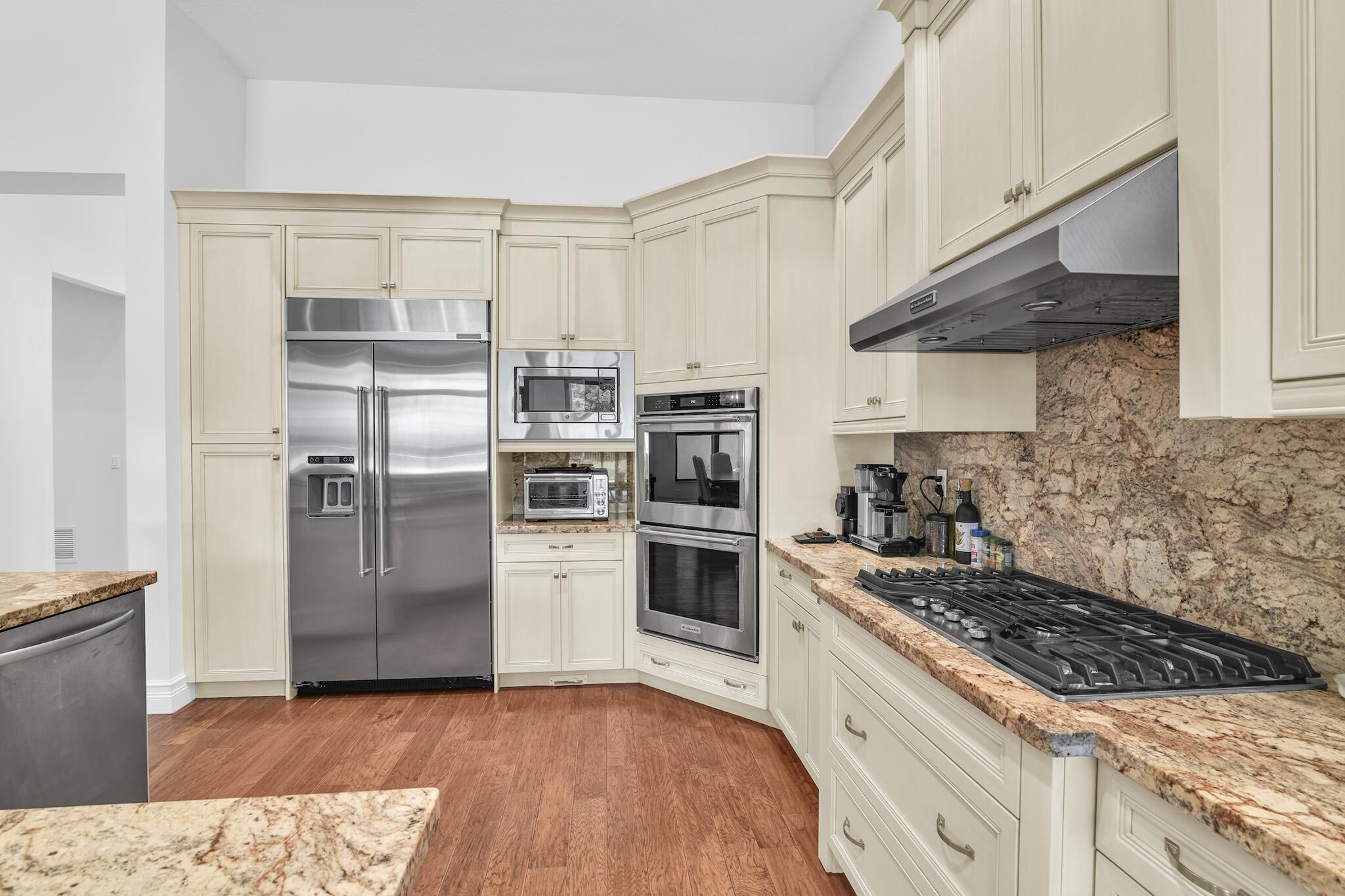 9577 Eden Roc Court Delray Beach, FL 33446 - Photo 4 of 53 a kitchen with a sink stainless steel appliances and view living room