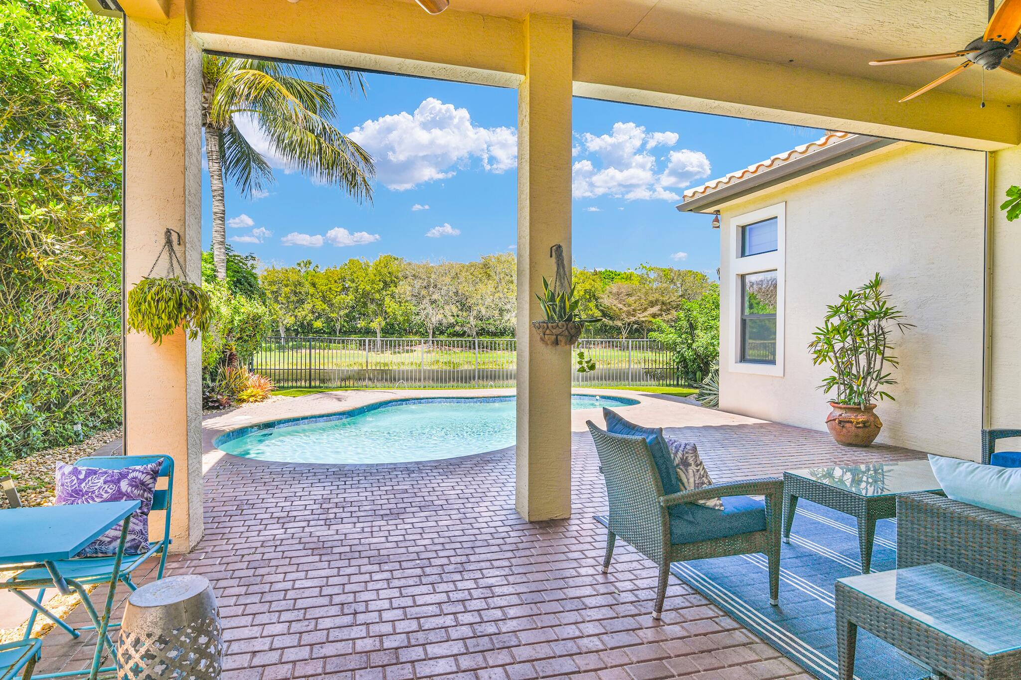 9577 Eden Roc Court Delray Beach, FL 33446 - Photo 7 of 53 a view of a swimming pool with a patio