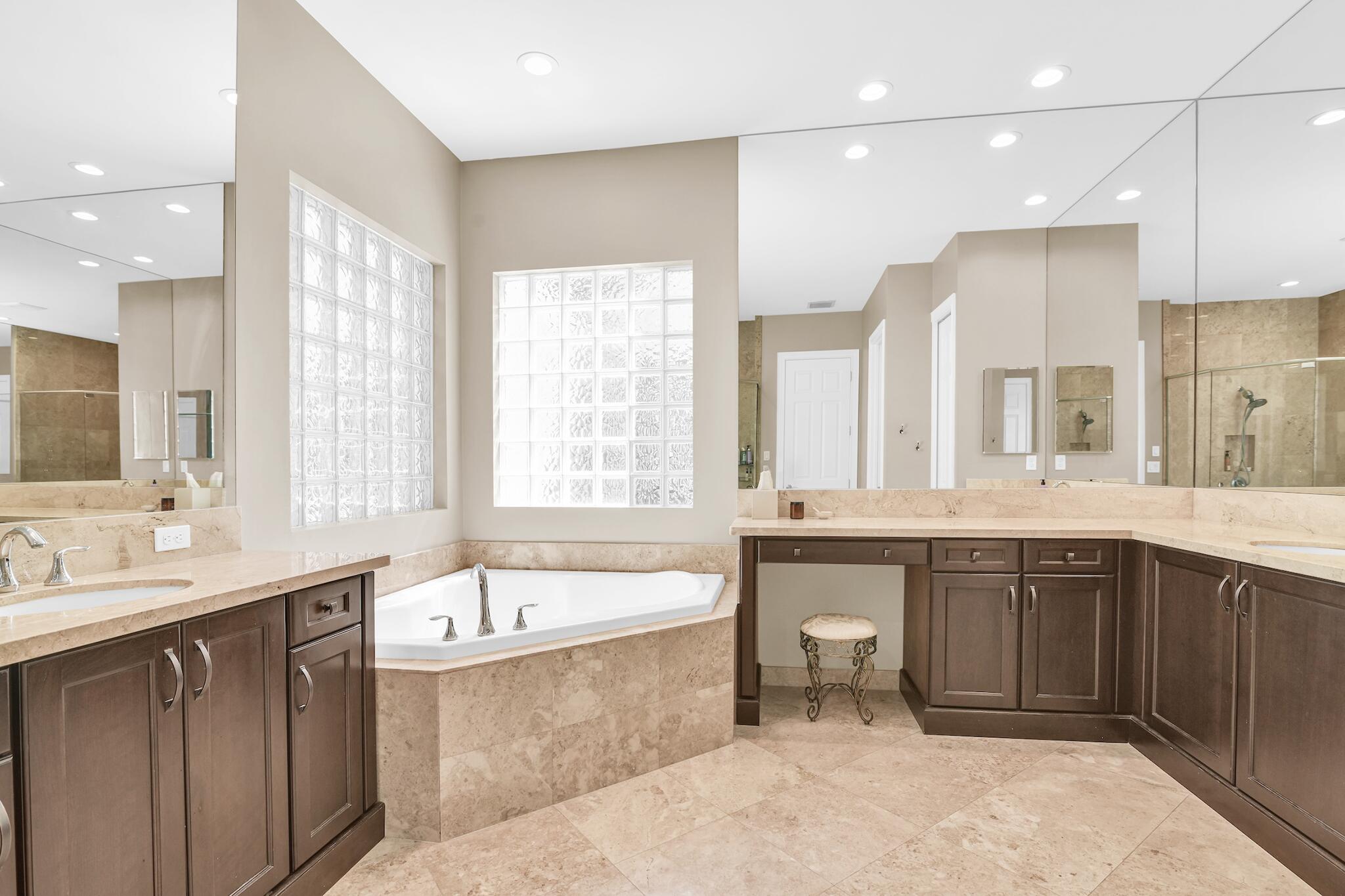 9577 Eden Roc Court Delray Beach, FL 33446 - Photo 9 of 53 a large bathroom with a large tub sink and double vanity