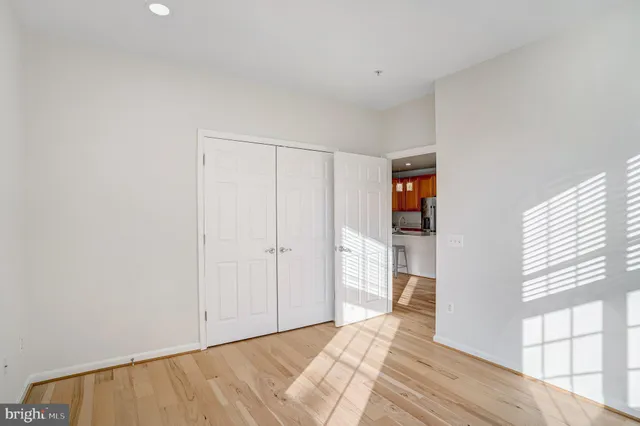 a view of bedroom with window and hardwood floor