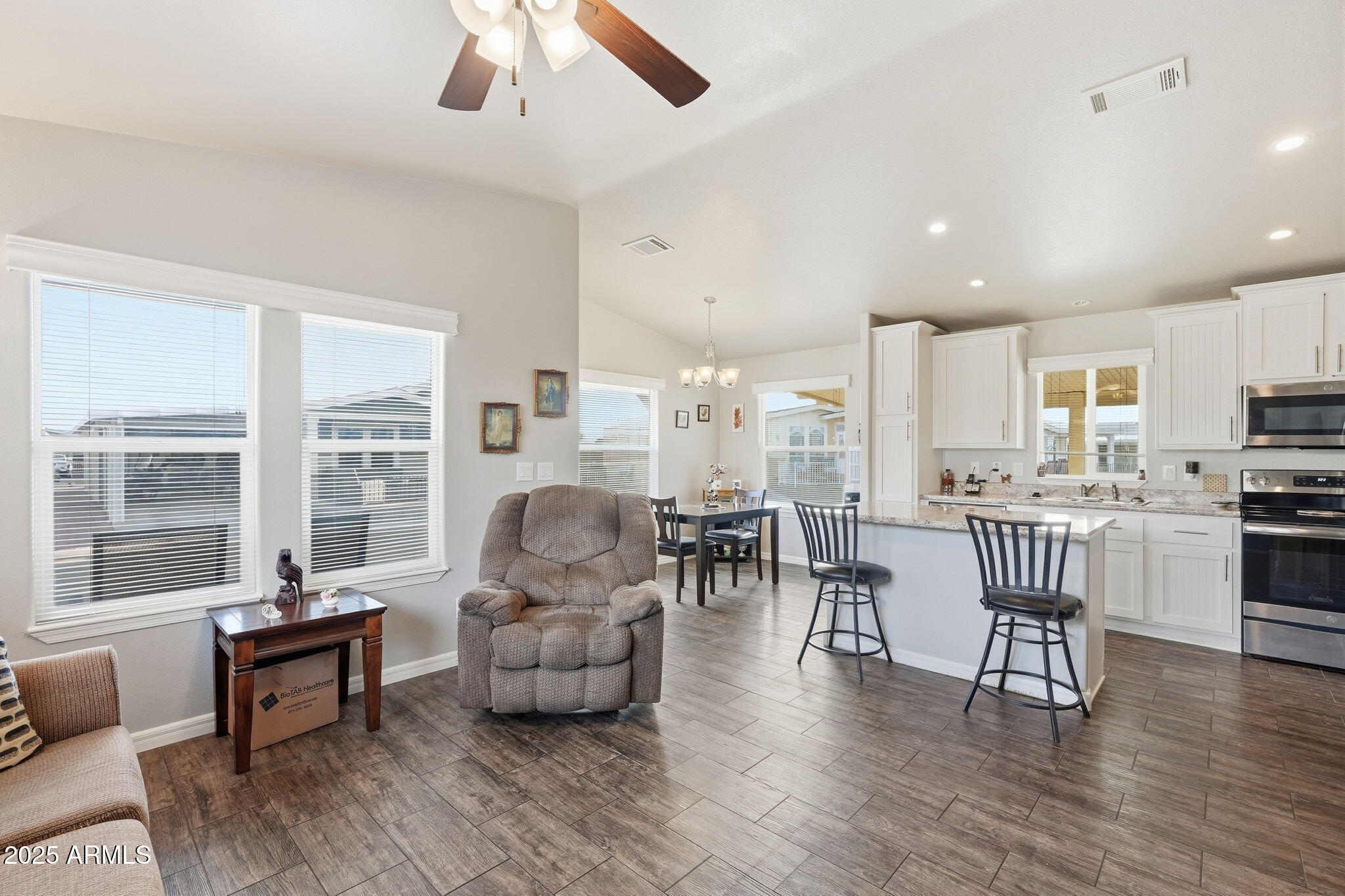 8865 East Baseline Road, Unit 558 Mesa, AZ 85209 - Photo 11 of 54 a living room with furniture and a wooden floor