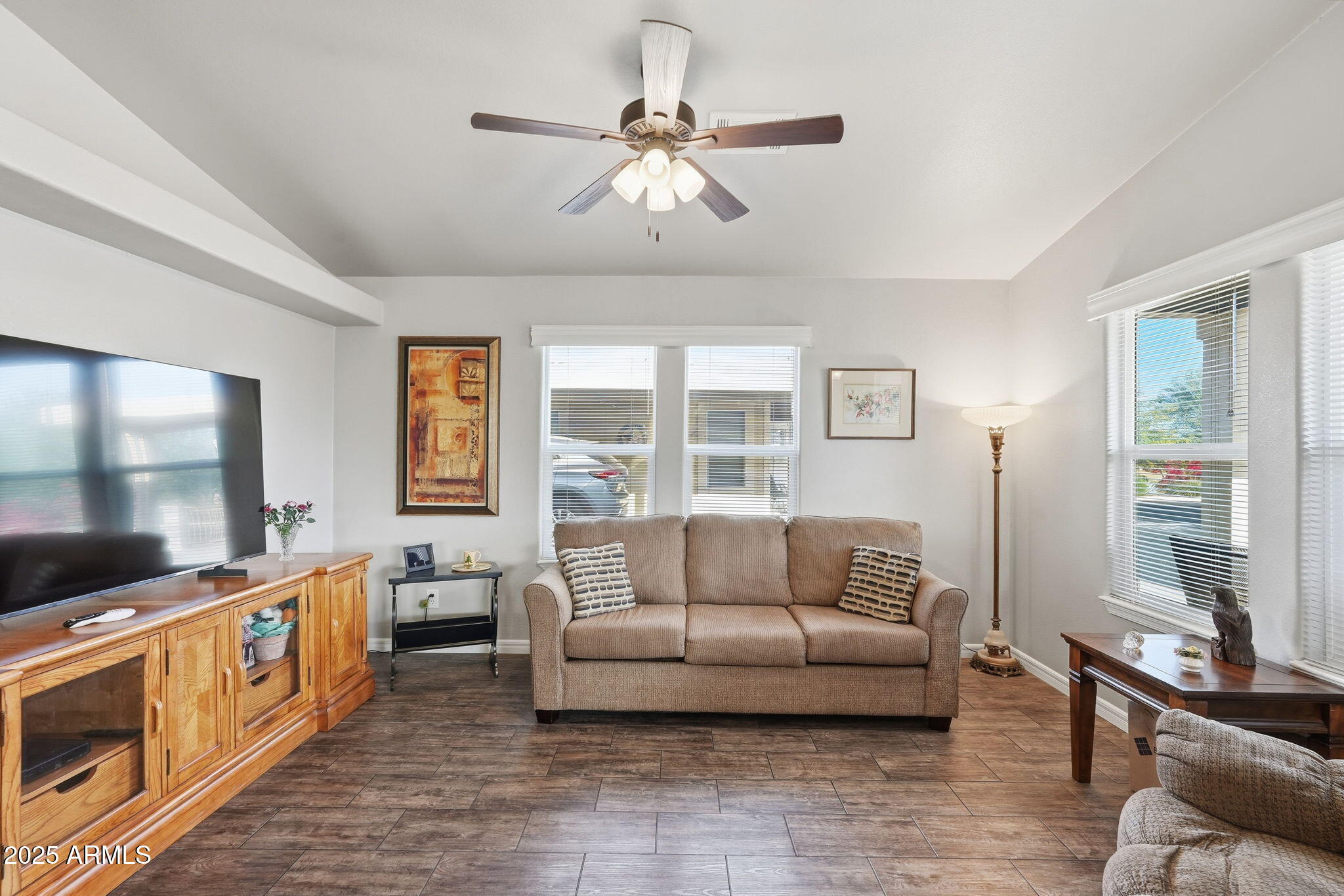 8865 East Baseline Road, Unit 558 Mesa, AZ 85209 - Photo 14 of 54 a living room with furniture and a flat screen tv