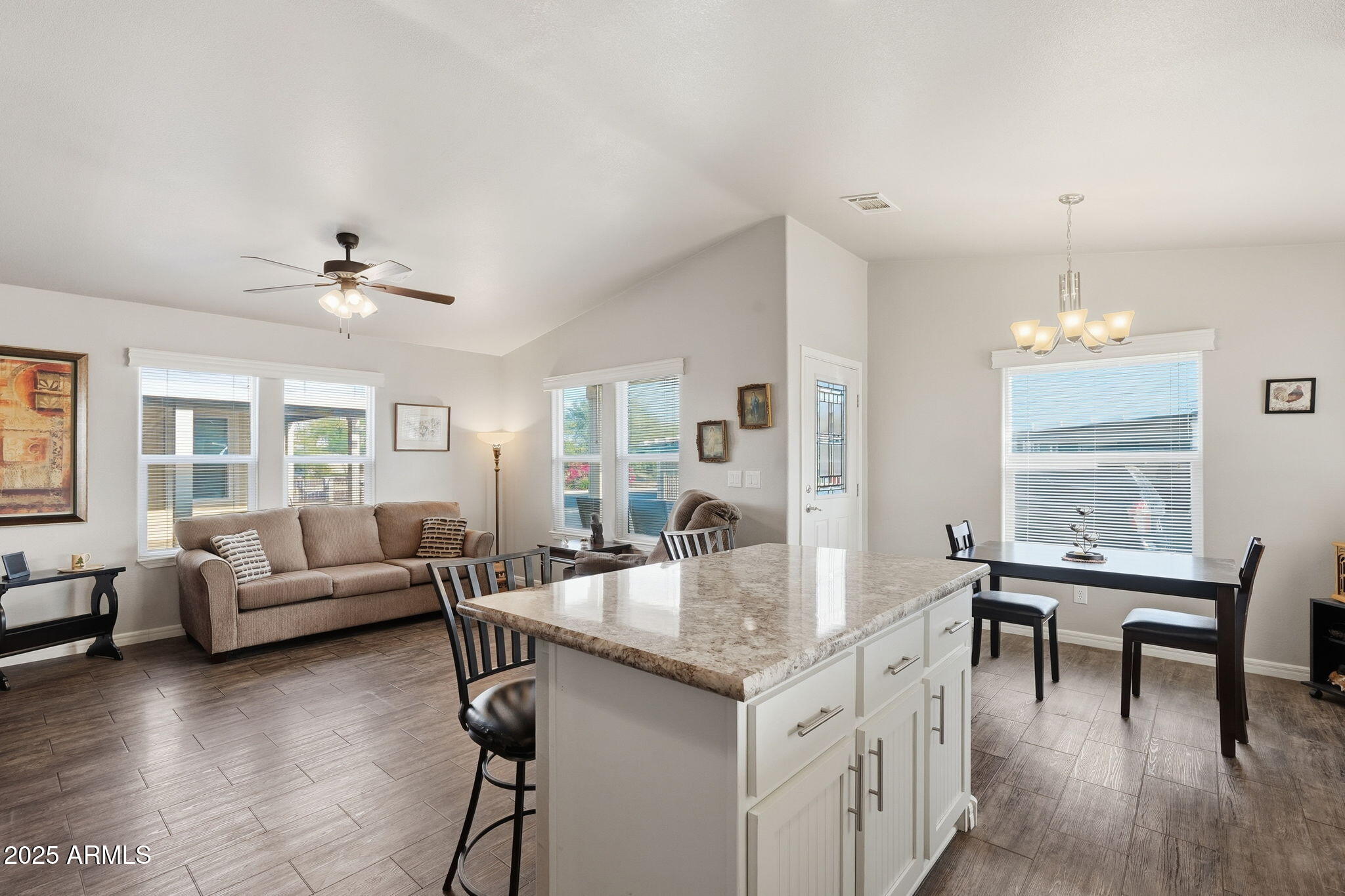 8865 East Baseline Road, Unit 558 Mesa, AZ 85209 - Photo 18 of 54 a living room with furniture and a wooden floor