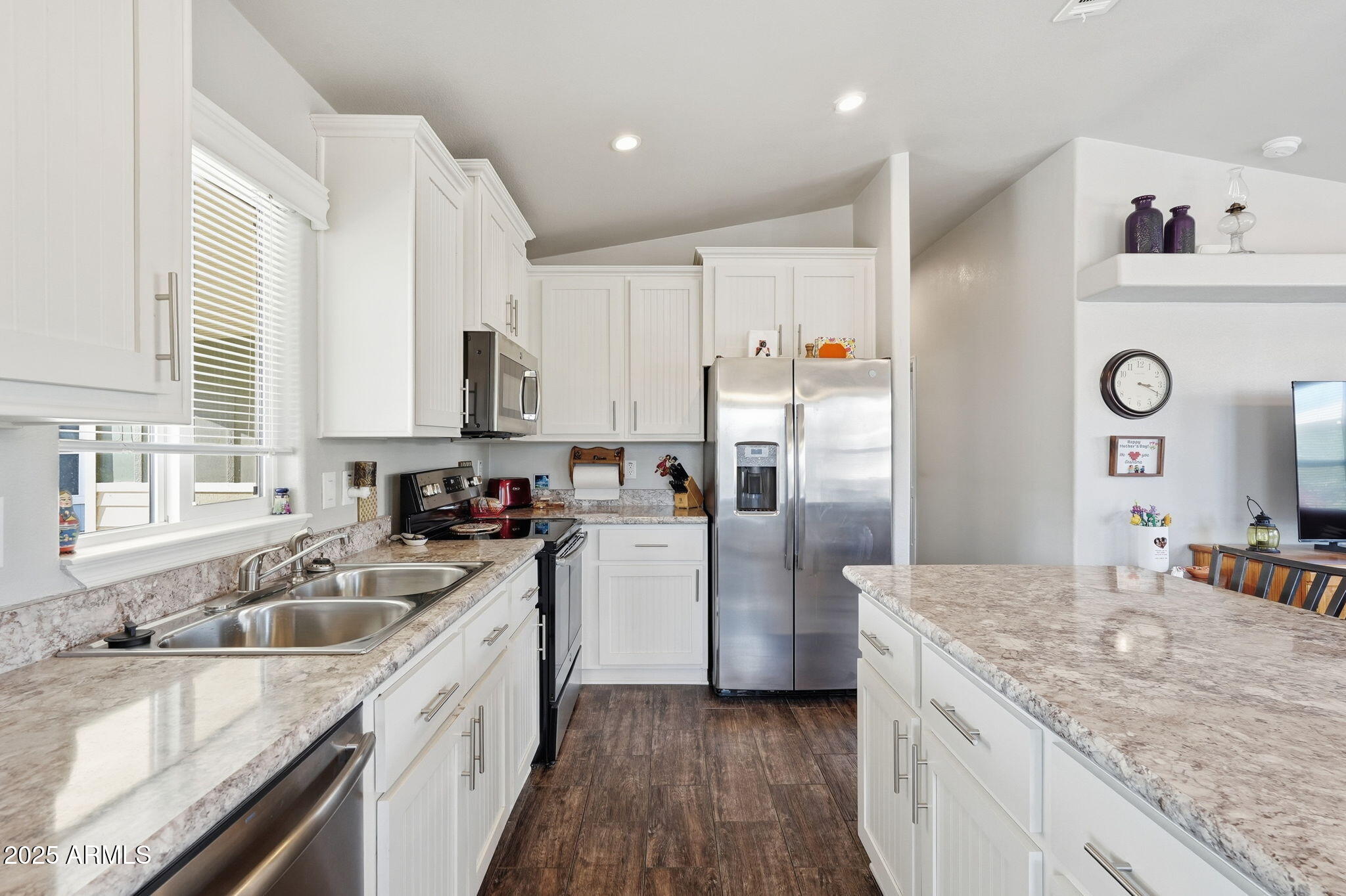 8865 East Baseline Road, Unit 558 Mesa, AZ 85209 - Photo 20 of 54 a kitchen with a sink a refrigerator a stove and wooden cabinets