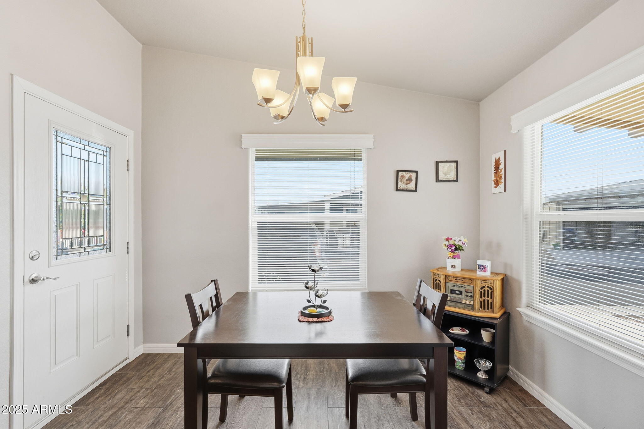 8865 East Baseline Road, Unit 558 Mesa, AZ 85209 - Photo 22 of 54 a view of a dining room with furniture window and wooden floor