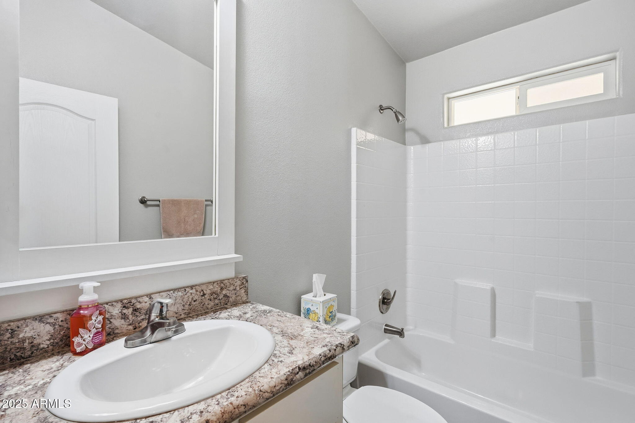 8865 East Baseline Road, Unit 558 Mesa, AZ 85209 - Photo 26 of 54 a bathroom with a granite countertop tub sink and mirror