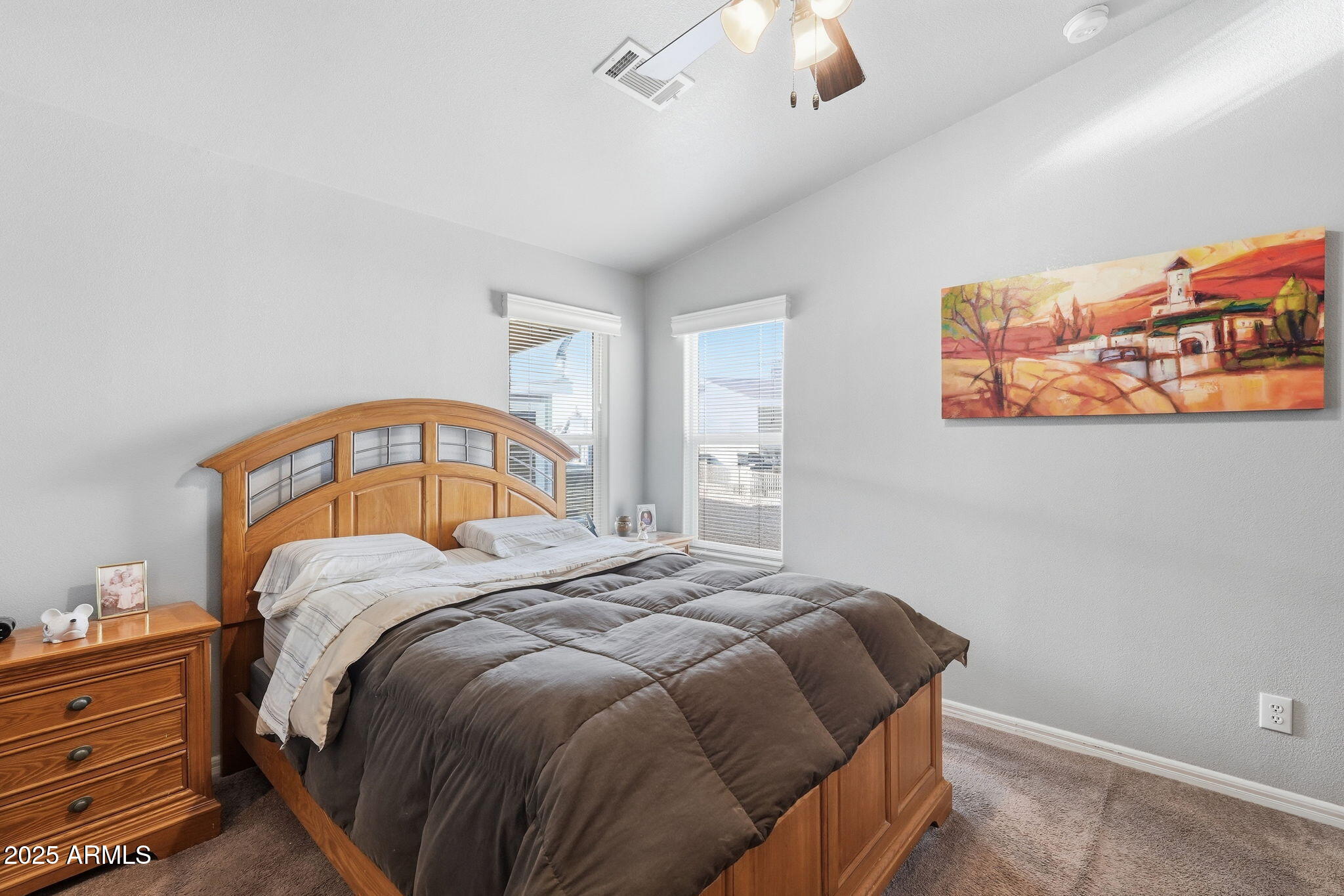 8865 East Baseline Road, Unit 558 Mesa, AZ 85209 - Photo 27 of 54 a bedroom with a bed and a chandelier