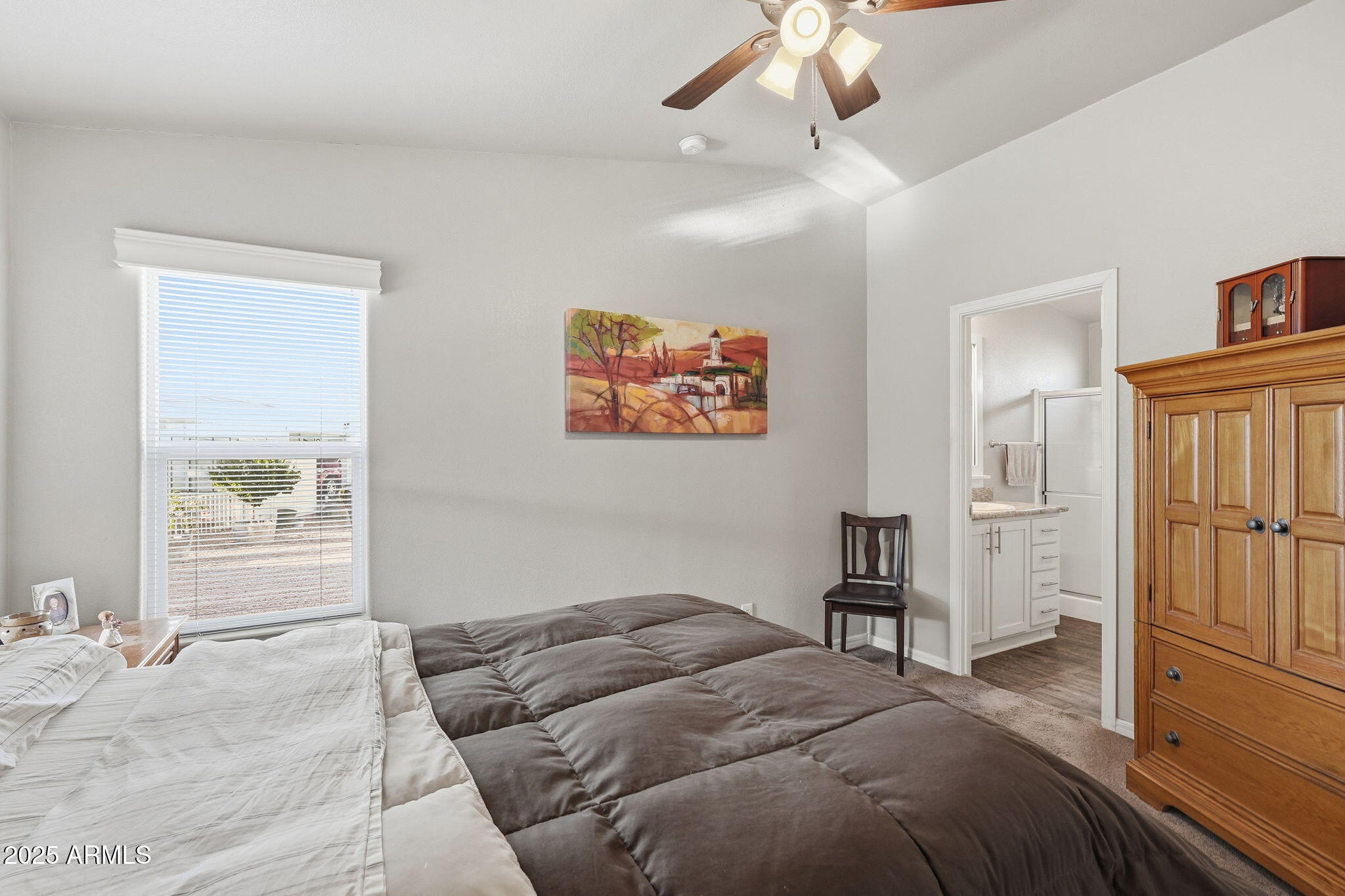 8865 East Baseline Road, Unit 558 Mesa, AZ 85209 - Photo 29 of 54 a bedroom with a bed and a chandelier