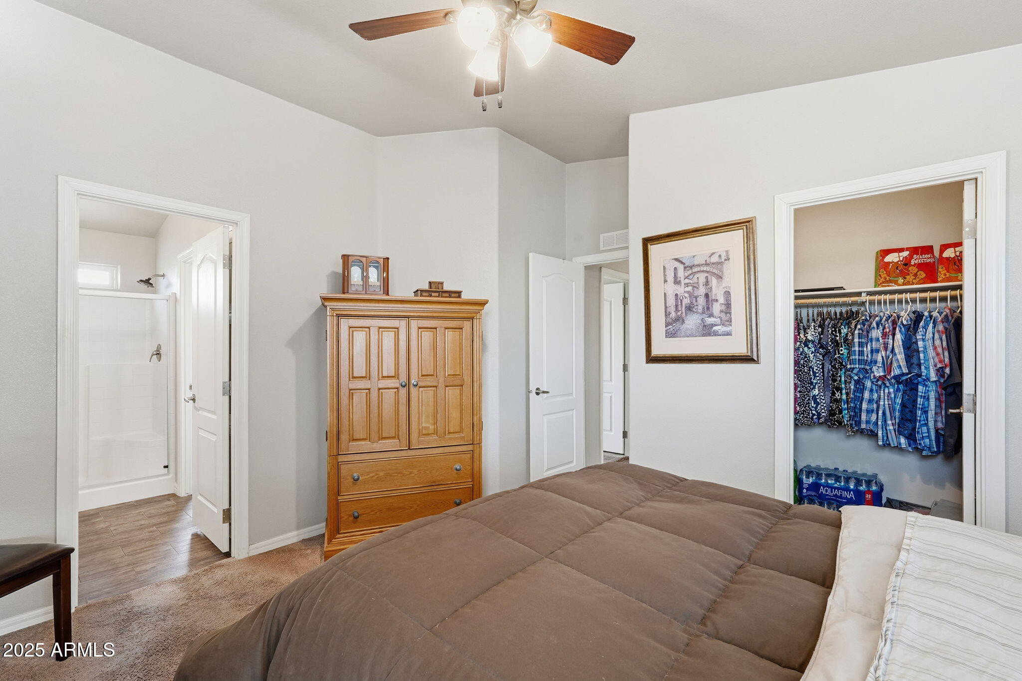 8865 East Baseline Road, Unit 558 Mesa, AZ 85209 - Photo 30 of 54 a bedroom with a bed and a chandelier