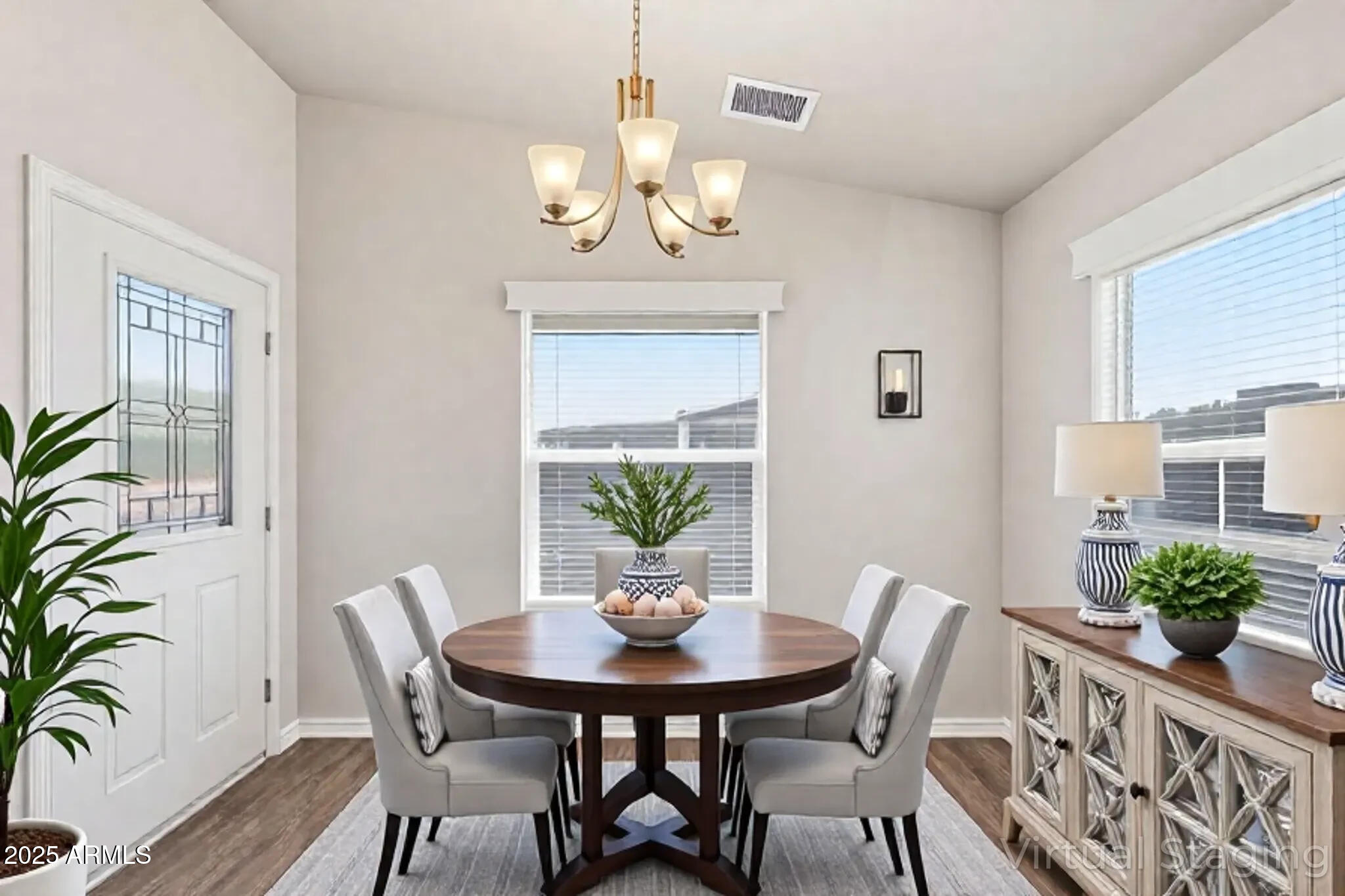 8865 East Baseline Road, Unit 558 Mesa, AZ 85209 - Photo 3 of 54 a view of a dining room with furniture window and wooden floor