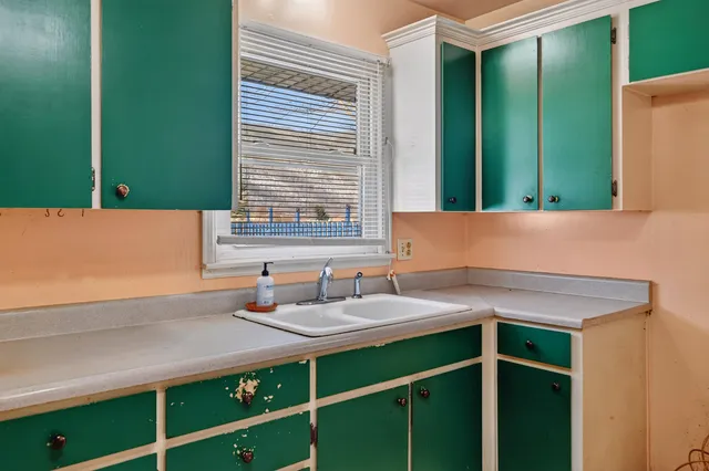 a bathroom with a sink and a window