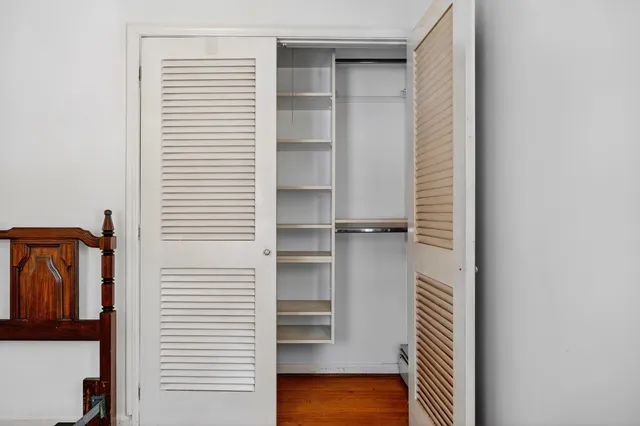 a view of walk in closet with empty racks