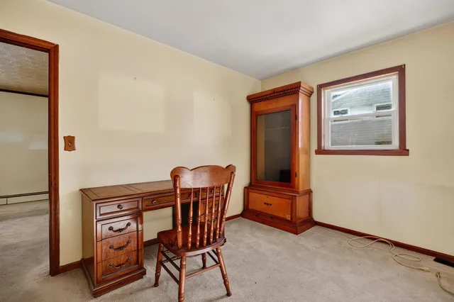 a view of a hallway with seating area