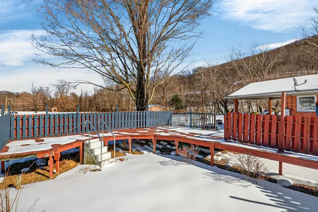 a balcony with hardwood table and chairs