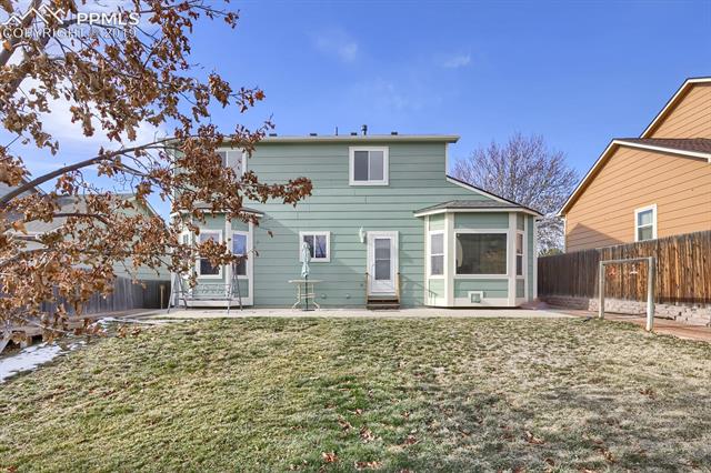 4415 Fencer Road Colorado Springs, CO 80911 - Photo 25 of 27 Exterior back with large concrete patio