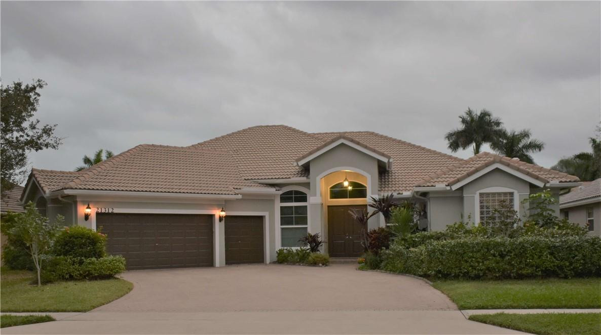 21312 Rock Ridge Drive Boca Raton, FL 33428 - Photo 1 of 1 a front view of a house with a yard and garage