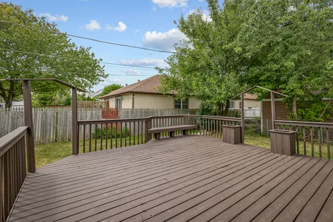 a view of backyard with deck and wooden floor