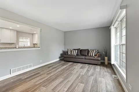 a view of wooden floor and windows in a room