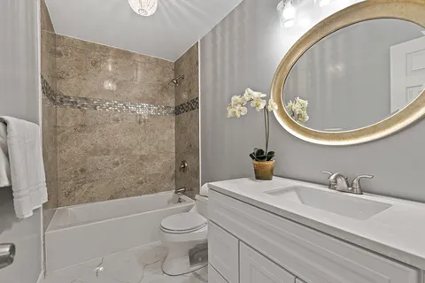 a bathroom with a sink a toilet and a mirror