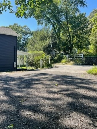 47 Bow Street Saugus, MA 01906 - Photo 11 of 31 a view of a yard with a wooden fence