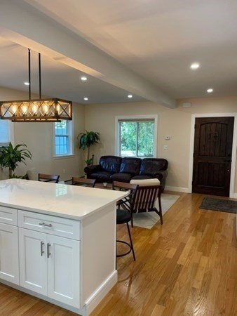 47 Bow Street Saugus, MA 01906 - Photo 23 of 31 a kitchen with a table chairs stove and wooden floor